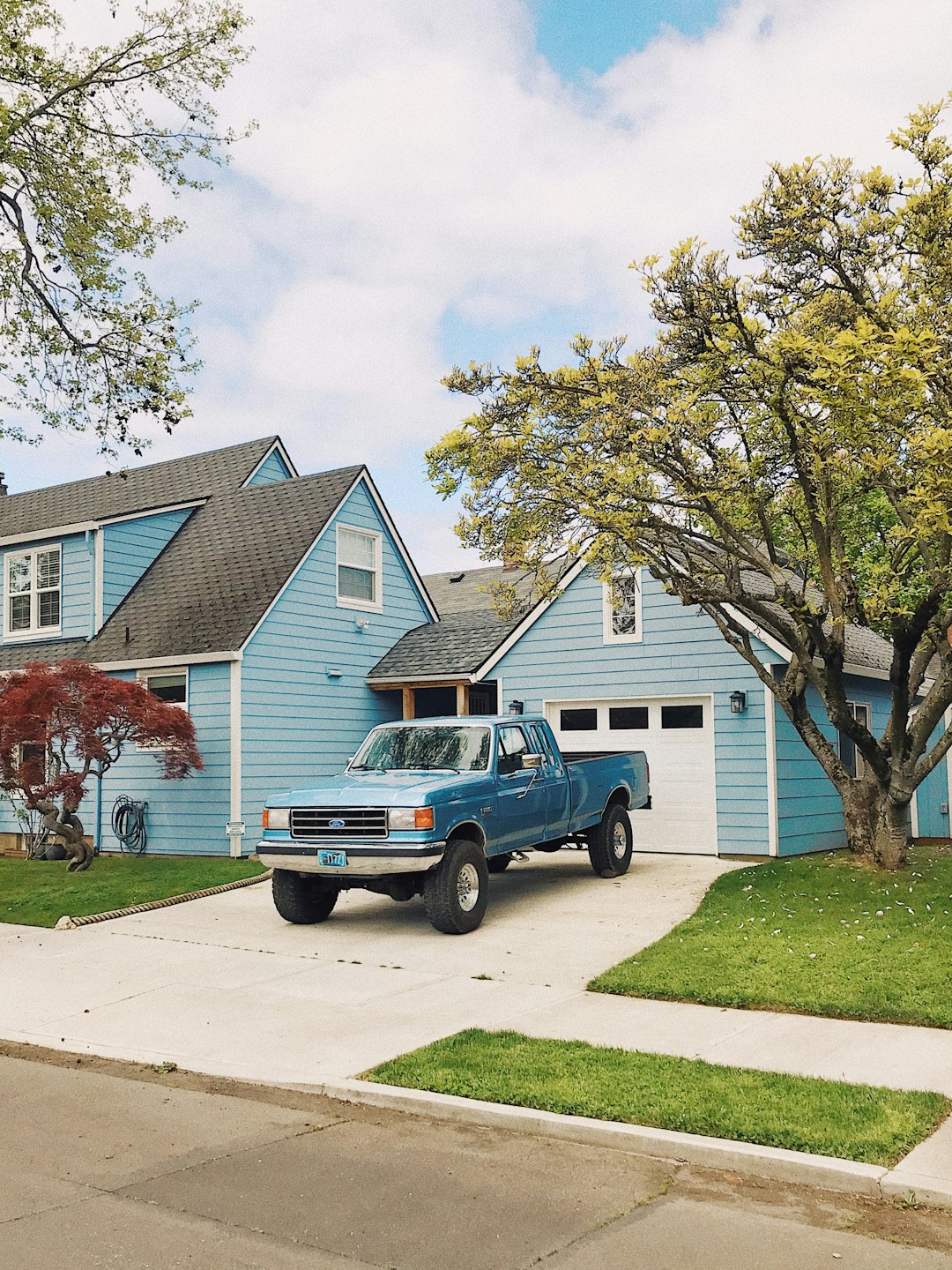 blue-chevrolet-crew-cab-pickup-truck-parked-beside-green-tree-during-daytime-4idksxgni2s